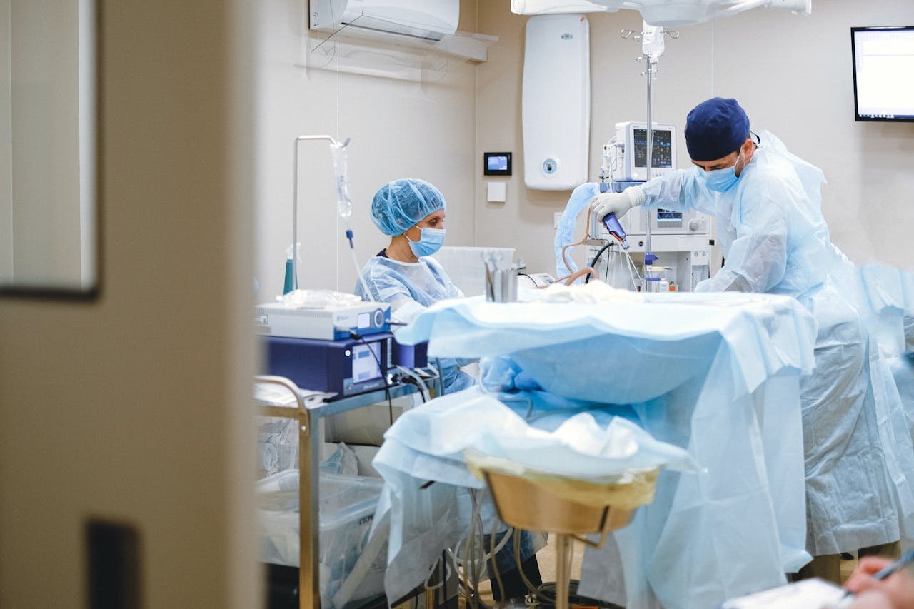 Surgeons and medical staff in a sterile operating room conducting a surgical procedure.
